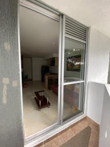 a view of a living room with a sliding glass window at Apartaestudio vacacional in Armenia