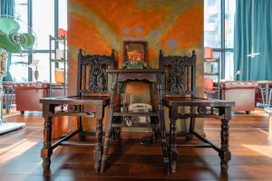 two chairs and a fireplace in a room at Zhangjiajie Wangyi Inn in Zhangjiajie