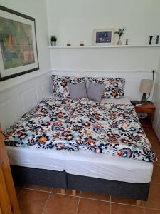 a bedroom with a bed with a floral comforter at Harzgeist in Goslar