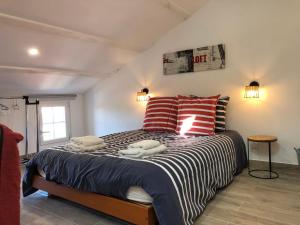 a bedroom with a large bed with two pillows at Le Logis de Virginie - climatisé in Rochefort