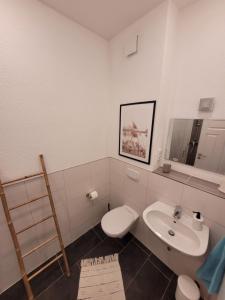 a bathroom with a toilet and a sink at Apartment mit beach flair in Garz-Rügen