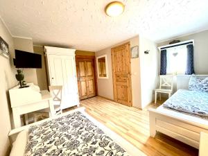 a bedroom with a bed and a desk in it at Land & Leben Pension in Chemnitz