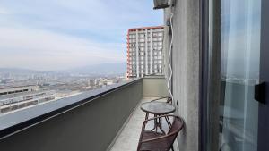 a stool sitting on the ledge of a balcony at Tbilisi Vi64 in Tbilisi City