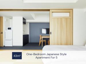 a room with a bed with a sliding door at MIMARU Osaka Shinsaibashi West in Osaka