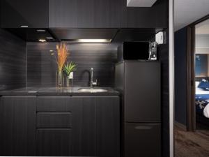 a kitchen with a sink and a refrigerator at MIMARU Osaka Shinsaibashi West in Osaka