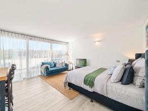 a bedroom with a bed and a chair and a window at XQ Collection La Casa De Frida - Modern Studio with Balcony in Sydney