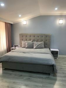 A bed or beds in a room at Candellux Imperial Hotel and Suites Abuja