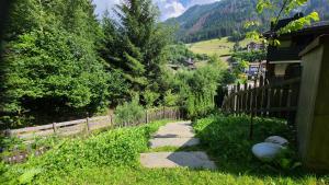 a path leading to a house with a fence at Villa Dolomiti in Ortisei