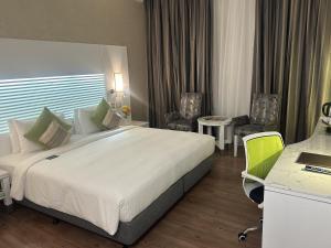 Krevet ili kreveti u jedinici u objektu Holiday Villa Hotel & Residence City Centre Doha