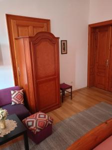 a living room with a couch and a cabinet at Apartment and rooms"Tabašnice"Tuzla centar in Tuzla