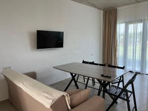 A television and/or entertainment centre at Cottages - Townhouses