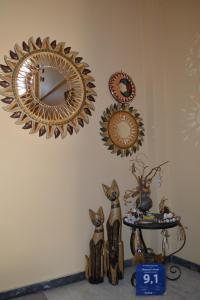 three mirrors on a wall with cats and a table at Chrysoula's Guests in Ioannina