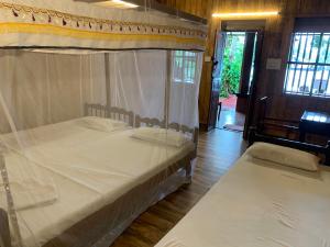 a bedroom with two bunk beds and a doorway at Malayalam Lake Resort in Alleppey