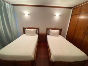 A bed or beds in a room at Casa da Mila