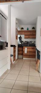 een keuken met houten kasten en een tegelvloer bij Gemme Fiorentine Apartments in front of the train station 5 minutes from the centre Free parking in Florence