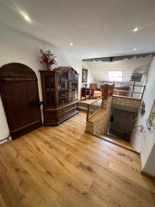 a large living room with wooden floors and a door at Nannerls Penthouse in Sankt Gilgen