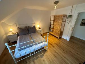 a bedroom with a bed with two night stands and two lamps at Nannerls Penthouse in Sankt Gilgen