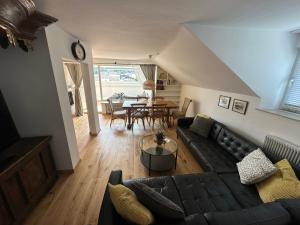 a living room with a couch and a table at Nannerls Penthouse in Sankt Gilgen