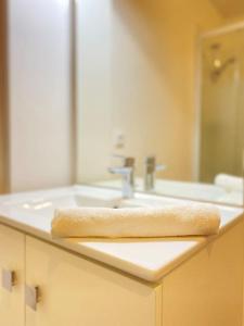 a bathroom sink with a towel on the counter at Le Péruvien - Saint-Cyr-L'Ecole - Free Parking in Saint-Cyr-lʼÉcole