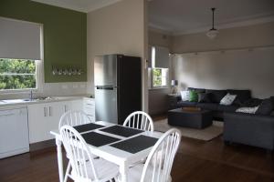 cocina y sala de estar con mesa y nevera en Victoria Street Apartments, en Grafton