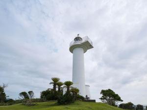 un faro en la cima de una colina con palmeras en HOTEL HOLISTIC RESORT - Vacation STAY 34557v, en Taiji