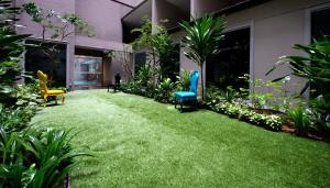 a yard with chairs and plants in a building at V Hotel Bencoolen in Singapore