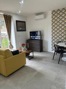 a living room with a couch and a table at Mozart Cosy Love room in Chasse-sur-Rhône