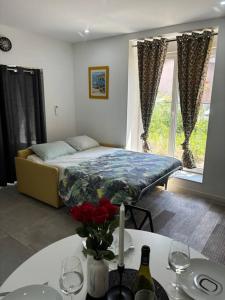 a bedroom with a bed and a table with wine glasses at Mozart Cosy Love room in Chasse-sur-Rhône