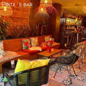 a living room with a couch and tables and chairs at Pintxos in Malmedy