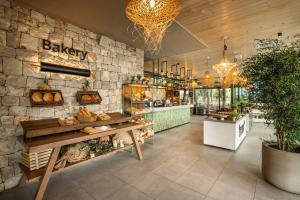 a bakery with a stone wall and a table at Valamar Amicor Resort in Stari Grad