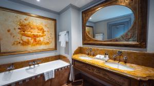 a bathroom with two sinks and a large mirror at Palazzo Hotel in Johannesburg