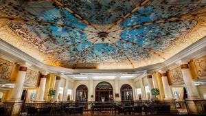 a room with a ceiling with a painting on it at Palazzo Hotel in Johannesburg