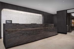 a lobby with a large marble counter in a building at Hilton Washington DC Capitol Hill in Washington