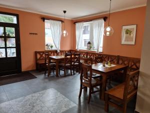 une salle à manger avec des tables et des chaises en bois dans l'établissement Hotel & Restaurace Pizzerie Jasany, à Znojmo