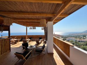 a balcony with chairs and a view of the ocean at Casa Boha in Dhërmi