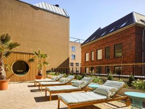 eine Reihe von Bänken in einem Innenhof neben einem Gebäude in der Unterkunft 25hours Hotel Indre By in Kopenhagen