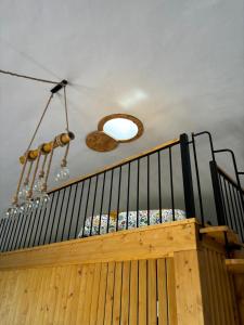 a wooden staircase with a chandelier and a ceiling at Casinhas dos Valados in Atouguia da Baleia