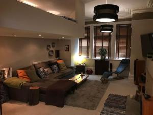 a living room with a couch and a chair at Large cosy flat in Southbourne near beaches in Bournemouth