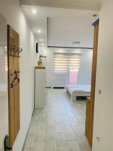 a hallway with a refrigerator in a room at Apartman Blue in Sombor