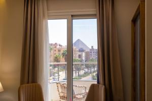 Zimmer mit einem Fenster und Stadtblick in der Unterkunft Khattab Pyramids View Hotel in Kairo