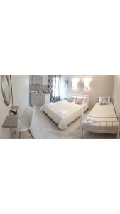 a bedroom with two beds and a mirror at Studios Thea Fresh Rooms Thassos in Limenas