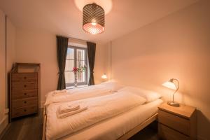 a bedroom with a large bed and a window at Dependance Penthouse in Interlaken