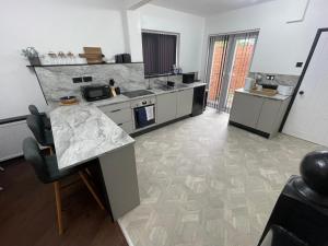 a kitchen with a counter and a counter top at Slick Space for a Standish Stay in Standish