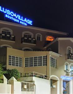 a building with a sign that reads university palace boutique hotel at Luso Village Boutique Hotel in Luso