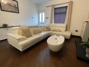 a living room with a white couch and a coffee table at Slick Space for a Standish Stay in Standish