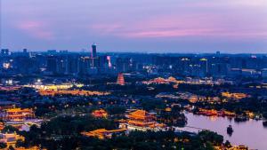 a city skyline at night with a river and buildings at Gran Melia Xi'an in Xi'an