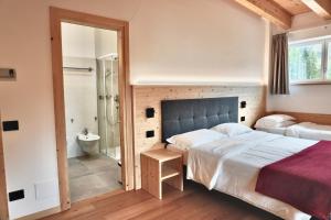 Una cama o camas en una habitación de Hotel Garni Civetta