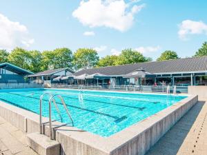 a large swimming pool with blue water at Holiday home Aabenraa LXXIX in Aabenraa