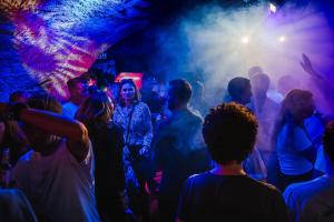 a group of people dancing in a club at Unique Hotel Post in Zermatt