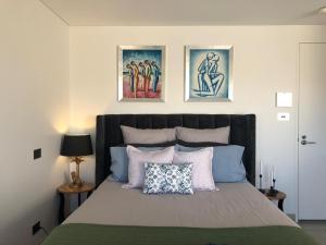 a bedroom with a bed with two pictures on the wall at XQ Collection La Casa De Frida - Modern Studio with Balcony in Sydney